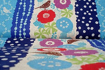 a picture of a roll of colourful fabrics