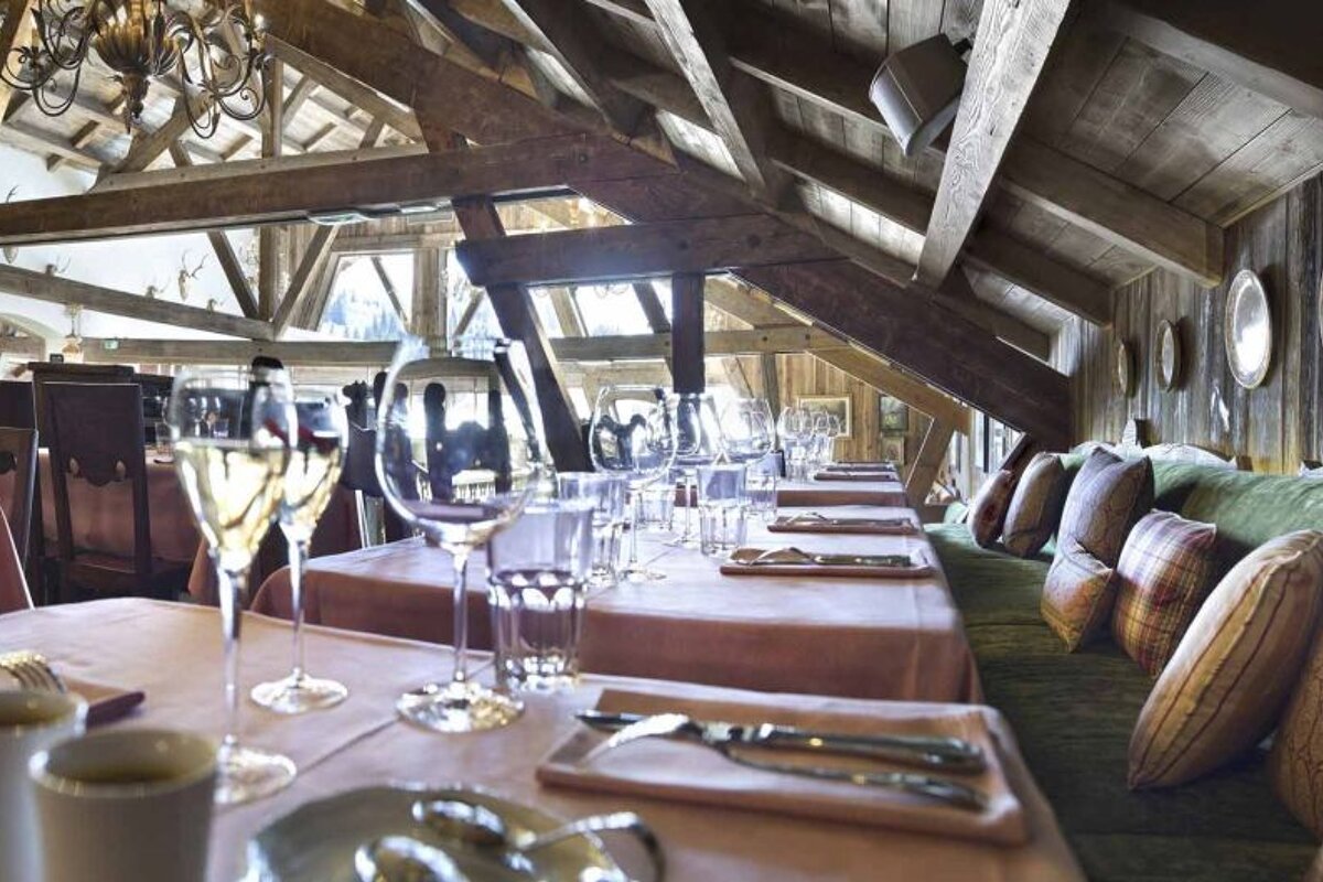 A dining room with tables and chairs and plates on the wall