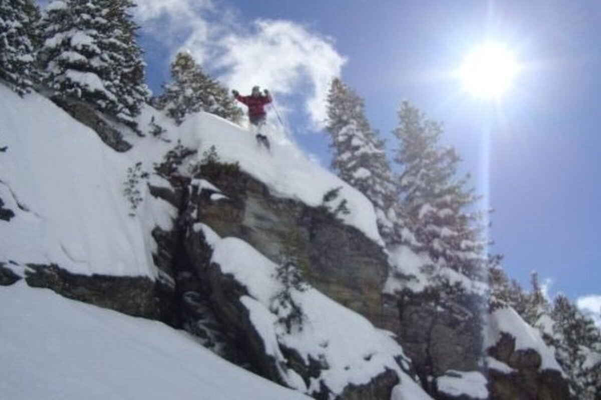 Photo of skier jumping cliff