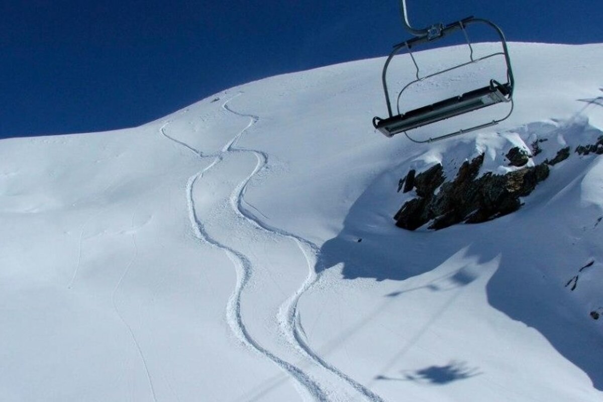 an image of fresh tracks under a chairlift