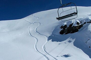an image of fresh tracks under a chairlift