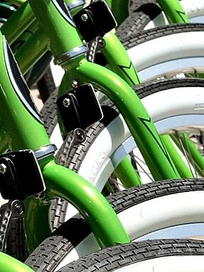 green bikes lined up in front of bike shop