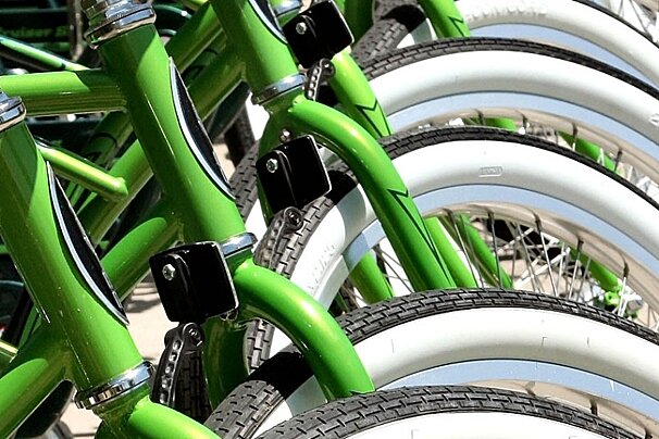 green bikes lined up in front of bike shop