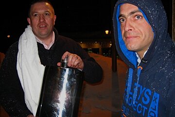 an image of two men with a giant hipflask