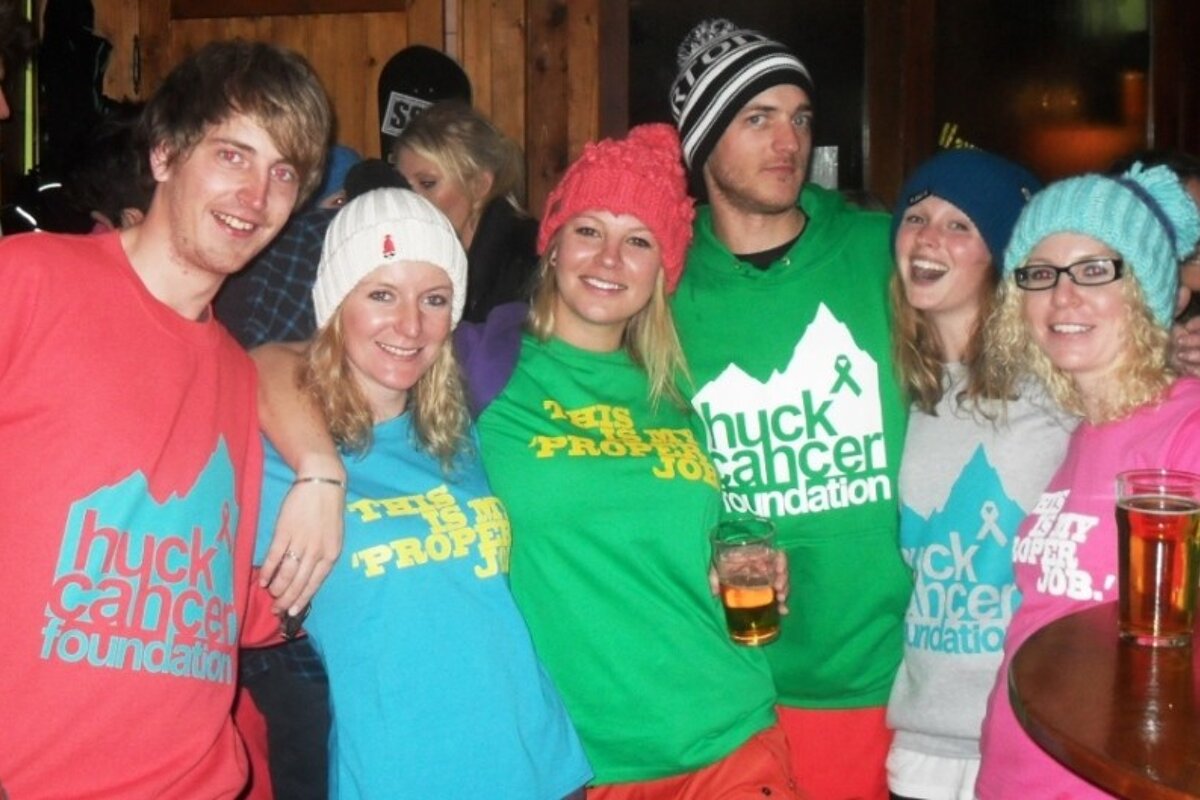 an image of people in a bar wearing huck cancer clothes