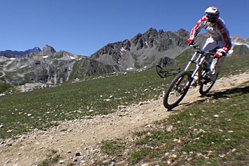 a picture of a mountain biker taking a left hand corner