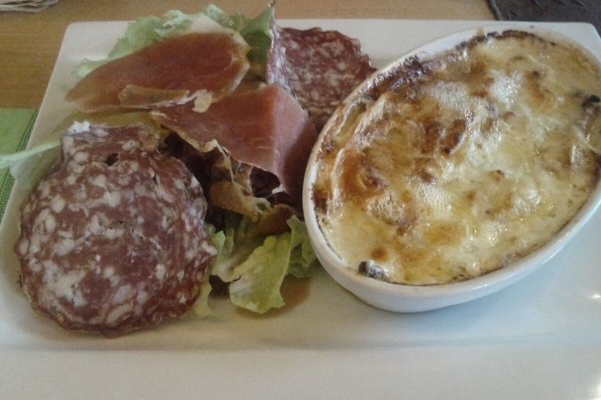 A plate of food with meat and cheese on it