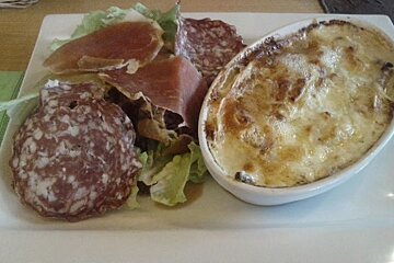 A plate of food with meat and cheese on it