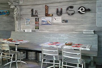 a picture of a restaurant name on a wall with tables and chairs