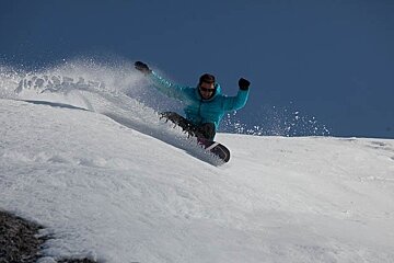 snowboarder blue sky blue jacket