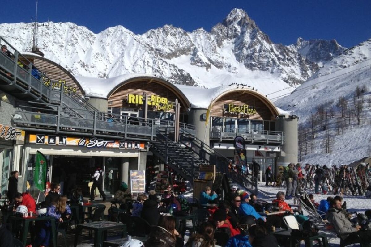 image of a mountain restaurant with lots of people sat on the terrace