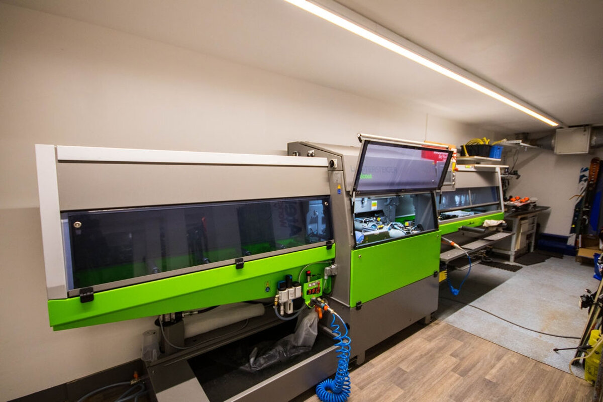 A machine with a green cover is sitting in a room