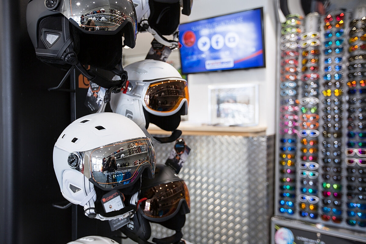 A display of ski helmets and goggles in a store