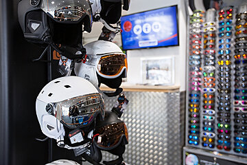 A display of ski helmets and goggles in a store
