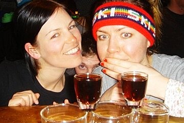 an image of two girls with shots in front of them