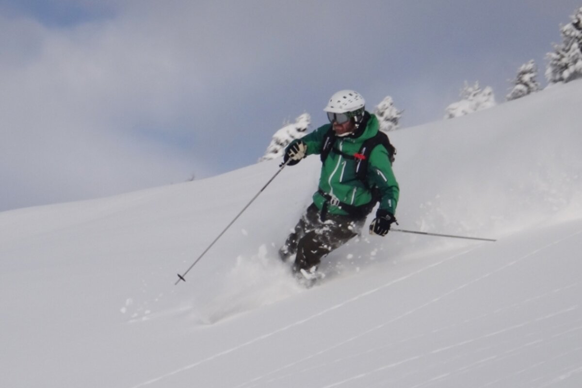 an image of a man powder skiing