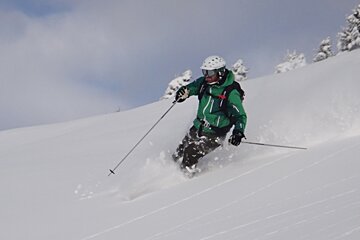 an image of a man powder skiing