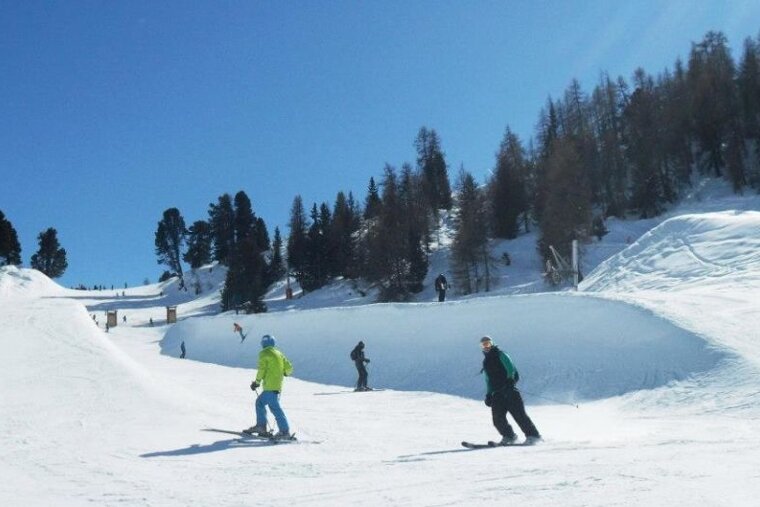 skiers in half pipe