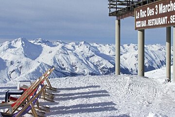 an image of deckchairs outside le roc des 3 marches val thorens