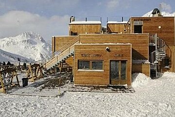 a picture of a mountain restaurant with wood cladding