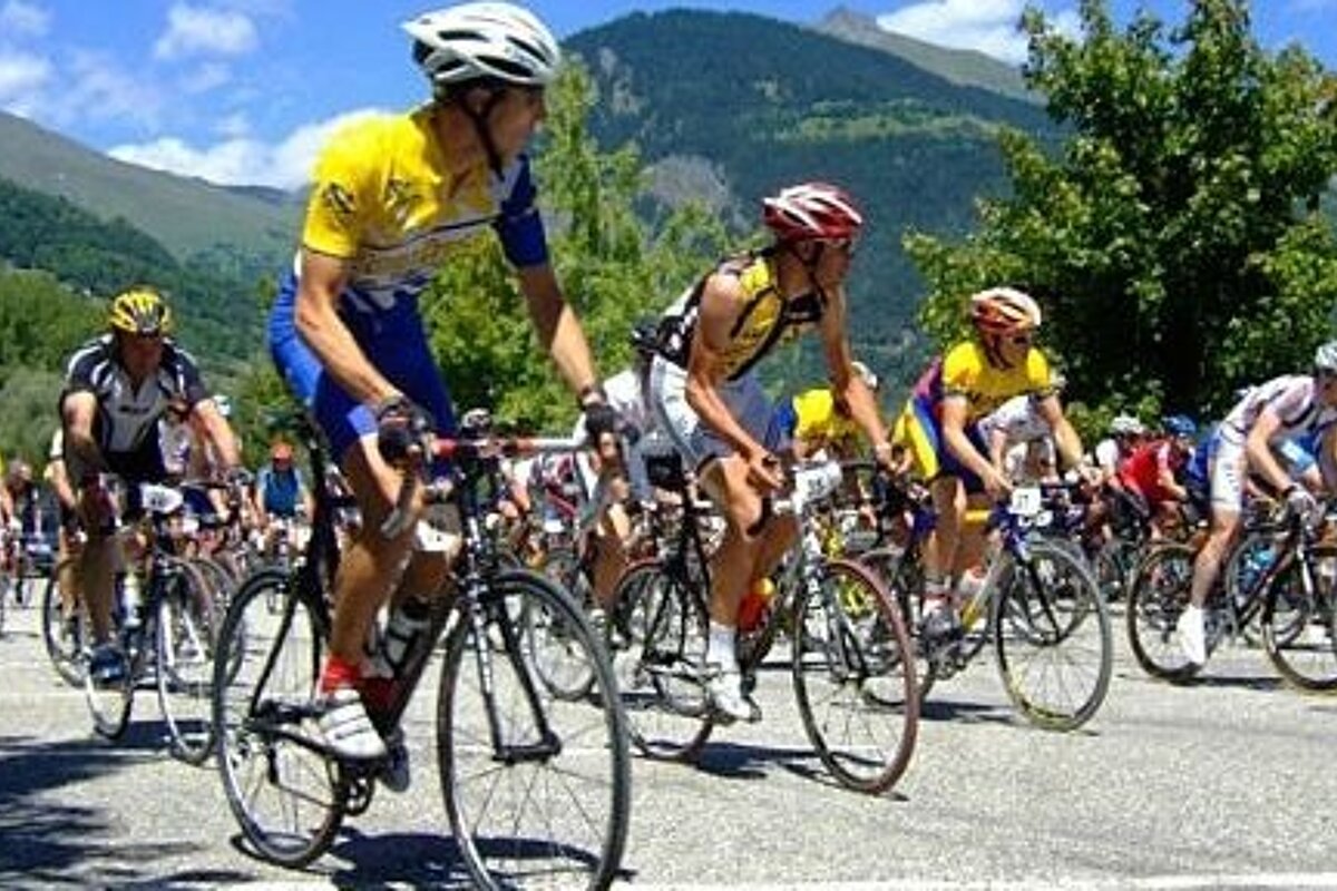 A group of people are riding bicycles down a road