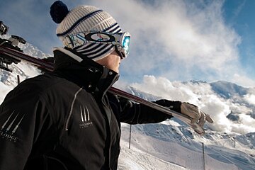 an image of a member of staff of the lodge verbier with skis