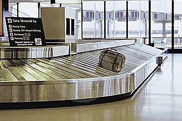 a single bag on a conveyor belt at the airport