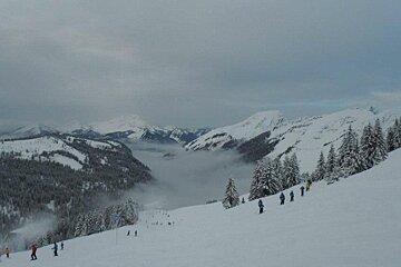 an image of mist in the valley in the portes du soleil