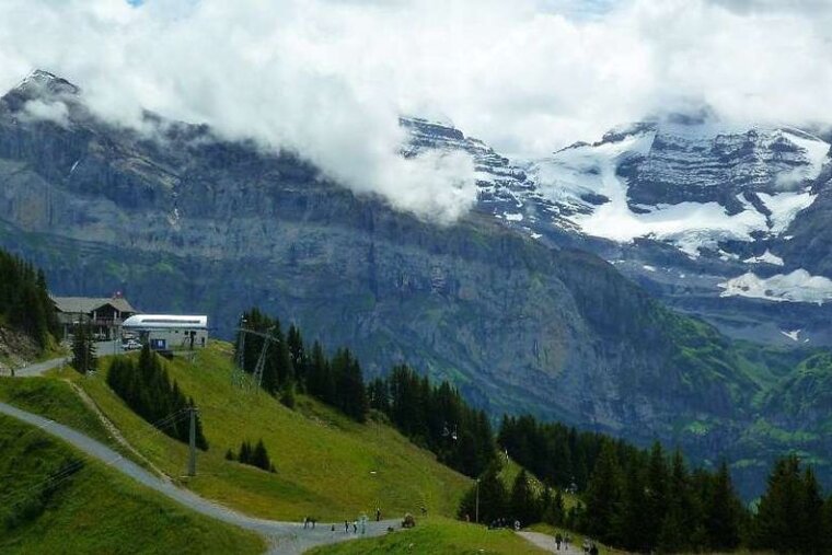 A ski lift is going up the side of a mountain