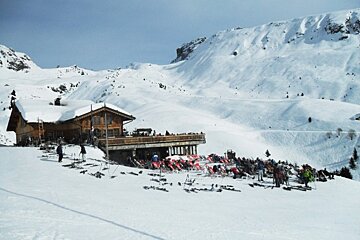 an image of a mountain restaurant and deckchairs