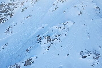 Huge avalanche crown and skiers tracks