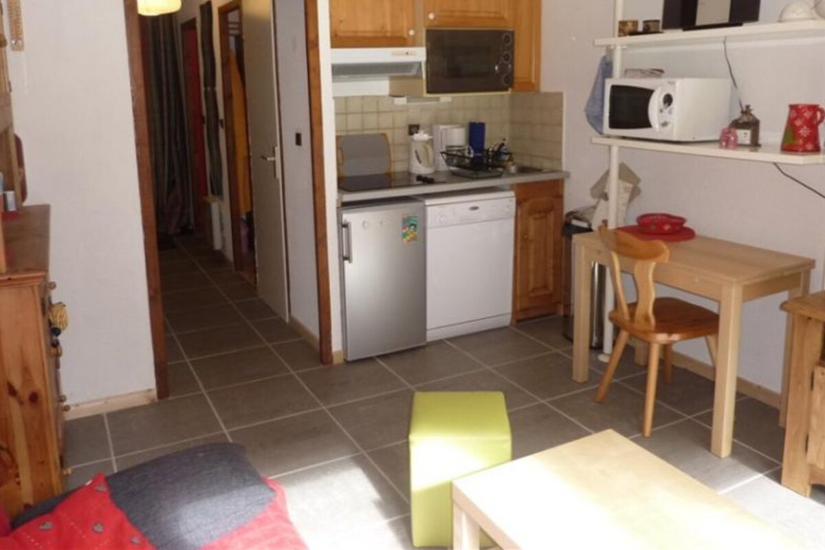 a picture of a kitchenette and living area in an apartment