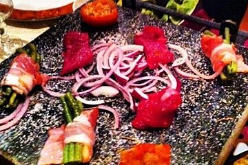 a picture of a hot stone with food cooking on it