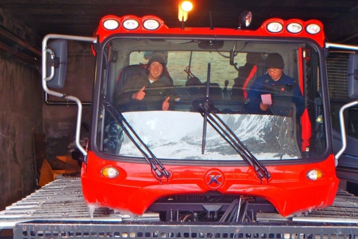 an image of people in a piste basher