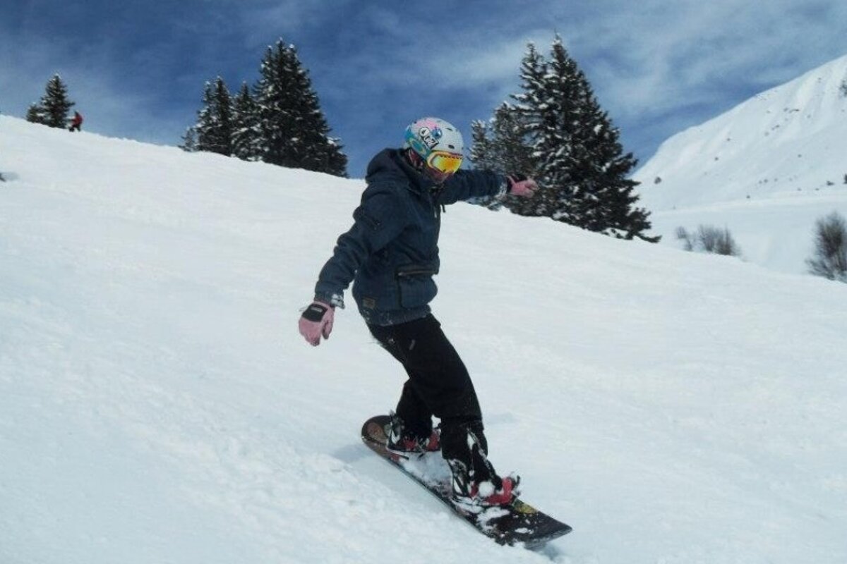 an image of a snowboarder on piste
