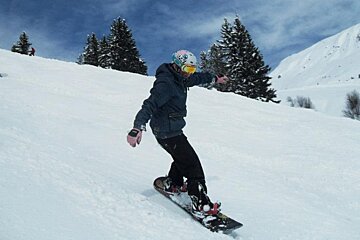 an image of a snowboarder on piste