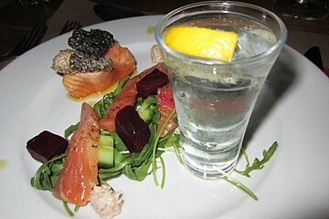 an image of salmon and a gin and tonic on a plate