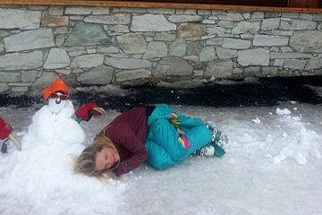an image of a girl lying on the floor in ski kit