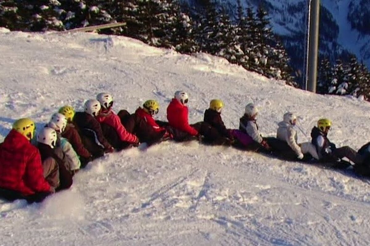 a train of people connected on sledges