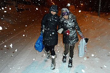 An image of people walking in the snow storm at night in Chamonix Mont Blanc