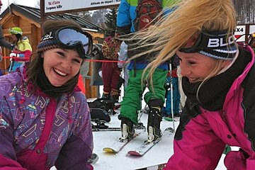 an image of two girls in ski one piece suits