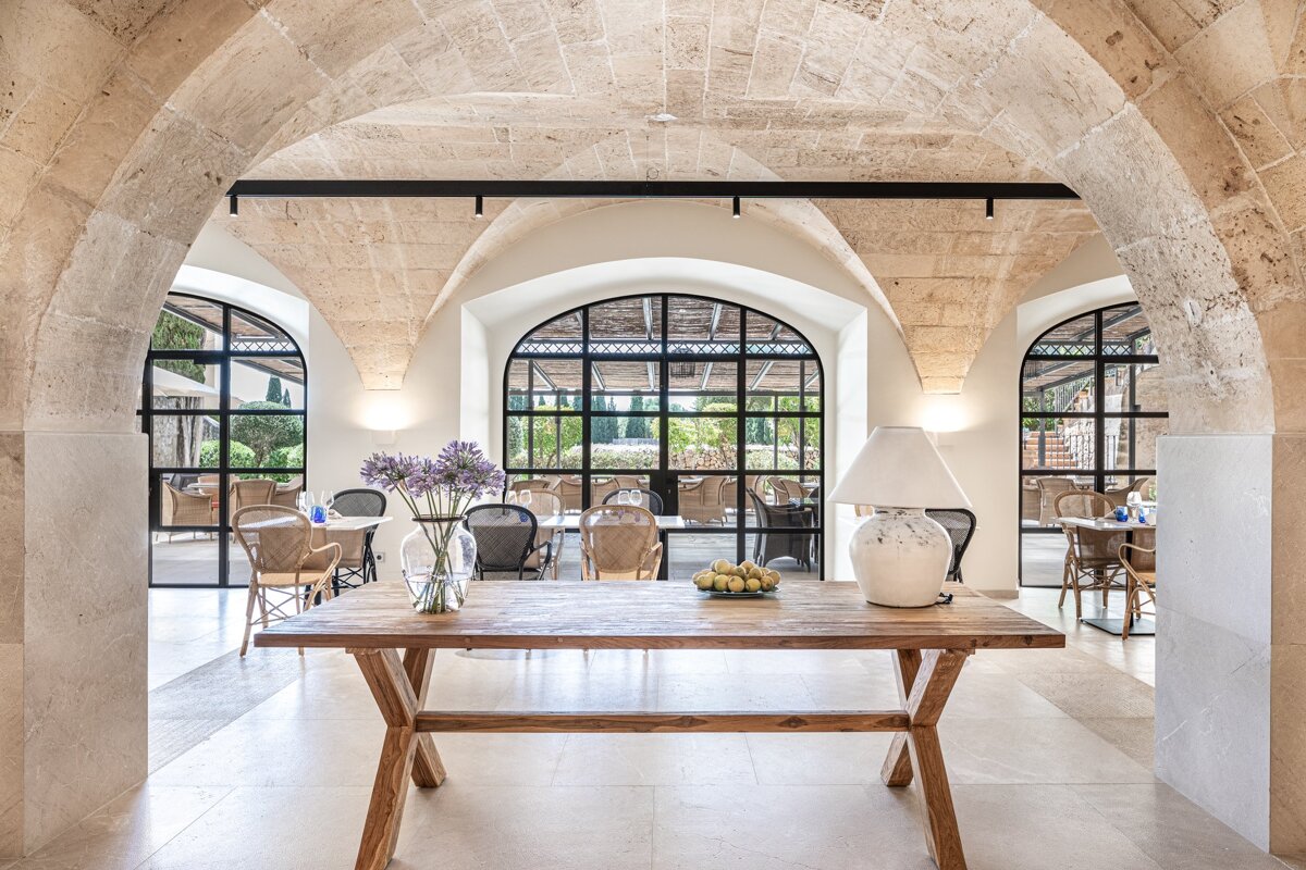 A table with a vase of flowers and a lamp on it