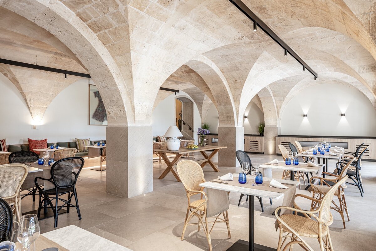A restaurant with arched ceilings and tables and chairs