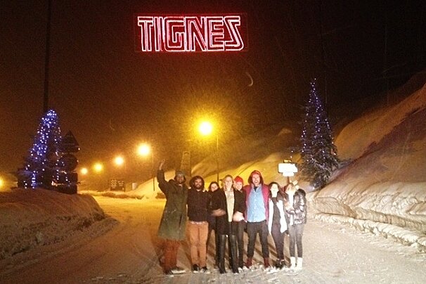 an image of a group of people under a tignes sign