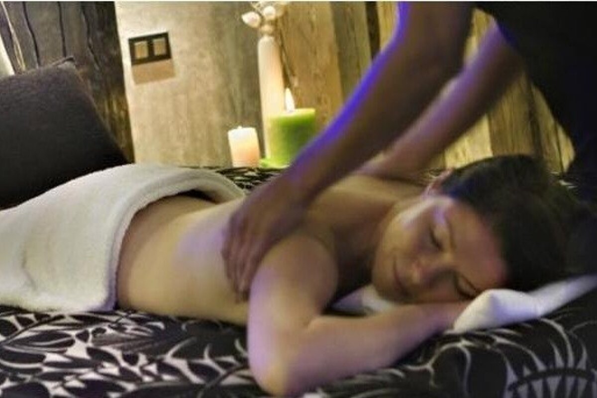 image of a woman lying on a massage table having a massage from person standing up