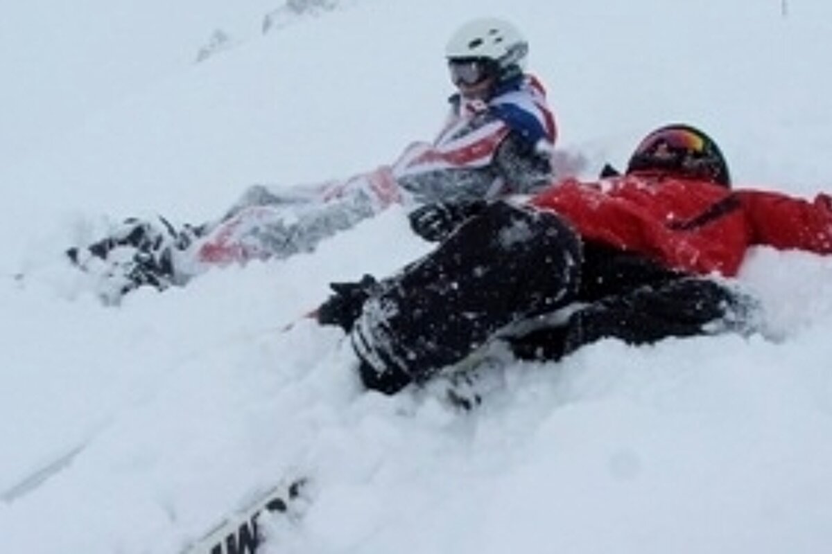 an image of a group of skiers lying in the snow