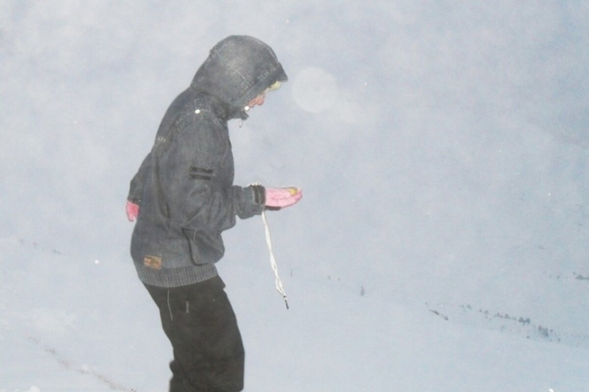 an image of someone looking at an avalanche transceiver