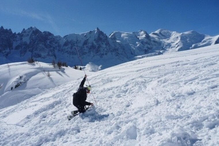 an image of avalanche transceiver practice with mont blanc behind