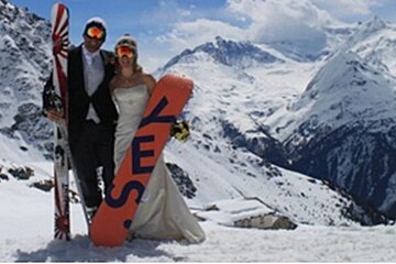 a picture of a couple in wedding clothes with snowboards