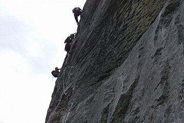 climbers on via ferrata alps